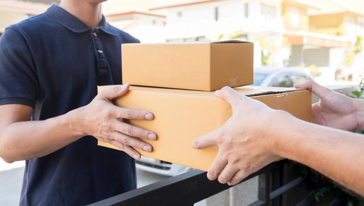Home delivery service delivers package at home and woman receiving by signing for online shopping orders